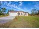 Charming single-story home with a well-manicured lawn, tidy landscaping, and a driveway at 9505 Luna Dr, St Cloud, FL 34773