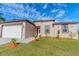 Charming single-story home with a well-manicured lawn and tidy landscaping at 9505 Luna Dr, St Cloud, FL 34773