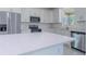Modern kitchen with stainless steel appliances, white countertops, and ample cabinet space at 9505 Luna Dr, St Cloud, FL 34773