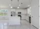 Bright, white kitchen featuring a kitchen island and stainless-steel appliances at 9505 Luna Dr, St Cloud, FL 34773