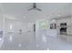 Spacious open-concept living area featuring white tile floors, recessed lighting, and modern stainless steel appliances at 9505 Luna Dr, St Cloud, FL 34773