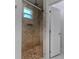 Tiled shower featuring a mosaic floor, rainfall showerhead, and built-in niche, offering spa-like experience at 9505 Luna Dr, St Cloud, FL 34773