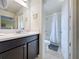 Bathroom with tub shower combo and dark brown vanity at 993 Suffolk Pl, Davenport, FL 33896