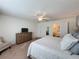 Main bedroom with ceiling fan, dresser, and ensuite bathroom at 993 Suffolk Pl, Davenport, FL 33896