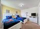 Bedroom with twin beds, Mickey Mouse decor, and a TV at 993 Suffolk Pl, Davenport, FL 33896