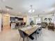 Open dining area with a long wooden table and seating for six at 993 Suffolk Pl, Davenport, FL 33896