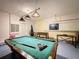 Game room features a pool table, foosball table, and seating at 993 Suffolk Pl, Davenport, FL 33896