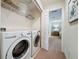 Convenient laundry room with washer, dryer, and shelving at 993 Suffolk Pl, Davenport, FL 33896