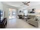 Living room with patio access, neutral decor, and comfortable seating at 993 Suffolk Pl, Davenport, FL 33896