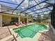 Large screened pool with spa and plenty of lounge chairs at 993 Suffolk Pl, Davenport, FL 33896