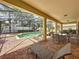 Covered patio with pool access, seating, and grill at 993 Suffolk Pl, Davenport, FL 33896