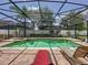 Screened pool and spa with lounge chairs for relaxation at 993 Suffolk Pl, Davenport, FL 33896