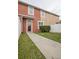 Townhouse exterior with a walkway and small yard at 10184 Hartford Maroon Rd, Orlando, FL 32827