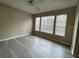 Bedroom with large windows and gray vinyl flooring at 1051 S Hiawassee Rd # 2112, Orlando, FL 32835