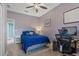 Bedroom with blue comforter, desk and gray nightstand at 1131 Blackwolf Run Rd, Davenport, FL 33836