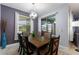 Dining room with wooden table, six chairs, and access to a screened porch at 1131 Blackwolf Run Rd, Davenport, FL 33836