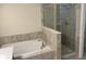 Bathroom with soaking tub and walk-in shower at 1144 Trappers Trail Loop, Davenport, FL 33896