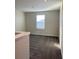 Bright bedroom with grey carpet and a large window at 1144 Trappers Trail Loop, Davenport, FL 33896