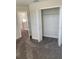 Bedroom with grey carpet, double door closet and access to another room at 1144 Trappers Trail Loop, Davenport, FL 33896