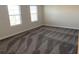 Bright bedroom with three windows and neutral carpeting at 1144 Trappers Trail Loop, Davenport, FL 33896