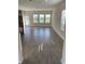 Spacious living area with grey tile flooring and large windows at 1144 Trappers Trail Loop, Davenport, FL 33896