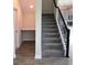 Staircase with grey carpeting, black railing, and built-in desk at 1144 Trappers Trail Loop, Davenport, FL 33896