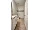 Clean bathroom with white tile and granite countertop at 115 W Murphy St, Davenport, FL 33837