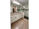 Double vanity bathroom with granite countertops and a walk-in shower at 115 W Murphy St, Davenport, FL 33837