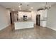 Open kitchen boasts white cabinets, granite countertops, and stainless steel appliances at 115 W Murphy St, Davenport, FL 33837