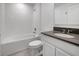 Clean bathroom with tub, toilet and dark vanity at 1274 Fury St, Davenport, FL 33837