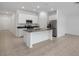 Modern kitchen with white cabinets, island, and stainless steel appliances at 1274 Fury St, Davenport, FL 33837