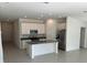 Modern kitchen featuring island, stainless steel appliances, and gray countertops at 1274 Fury St, Davenport, FL 33837