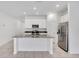 Modern kitchen with island, stainless steel appliances, and white cabinets at 1274 Fury St, Davenport, FL 33837