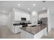 Modern kitchen with white cabinets, island, and stainless steel appliances at 1274 Fury St, Davenport, FL 33837