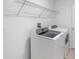 Bright laundry room with washer, dryer and overhead shelving at 1274 Fury St, Davenport, FL 33837