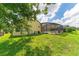 Large backyard with grassy area and screened pool enclosure at 135 Langham Dr, Davenport, FL 33897