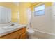 Clean bathroom with wood vanity, tiled tub/shower, and single sink at 135 Langham Dr, Davenport, FL 33897