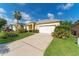 Single-story yellow house with a neatly landscaped yard at 135 Langham Dr, Davenport, FL 33897