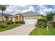 Eye-catching yellow house with a gray roof, and well-maintained lawn at 135 Langham Dr, Davenport, FL 33897