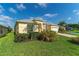 Single-story house with gray roof, yellow walls, and manicured lawn at 135 Langham Dr, Davenport, FL 33897