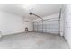 Empty garage with white walls and automatic garage door at 135 Langham Dr, Davenport, FL 33897