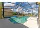 Relaxing pool area with covered patio and string lights at 135 Langham Dr, Davenport, FL 33897