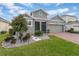 Two-story house with gray exterior, red brick driveway, and landscaping at 1445 Rosedale Rd, Davenport, FL 33837