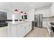 Open concept kitchen with island, stainless steel appliances, and white cabinets at 1481 Discovery St, Davenport, FL 33896