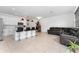 Modern kitchen with white cabinets, breakfast bar, and tile floors at 1481 Discovery St, Davenport, FL 33896