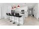 White kitchen with island, breakfast bar, and red pendant lights at 1481 Discovery St, Davenport, FL 33896