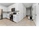 Modern kitchen with white cabinets, stainless steel appliances, and tile floor at 1481 Discovery St, Davenport, FL 33896
