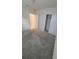 Spacious bedroom with gray carpet, double door closet, and access to bathroom at 1511 Woodmont Blvd, Kissimmee, FL 34746