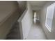 Bright entryway with tile flooring, staircase, and view to living area at 1511 Woodmont Blvd, Kissimmee, FL 34746