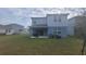 Back of house showing patio and yard at 1511 Woodmont Blvd, Kissimmee, FL 34746